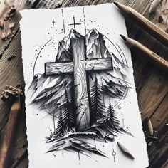 a drawing of a cross with mountains and pine trees in the background, surrounded by crucifix pencils