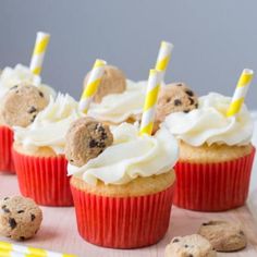 chocolate chip cookie cupcakes with white frosting and yellow striped paper straws