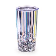 a multicolored tumbler is shown with glitter in the bottom and inside, on a white background