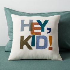 a pillow with the words hey, kid on it