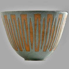 a brown and white bowl with lines on it