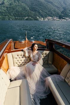 a woman sitting on the back of a boat