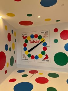 the room is decorated with multicolored dots and has a large clock on it