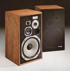 two speakers sitting next to each other on top of a table