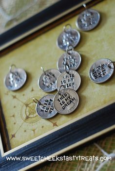 a group of silver coins sitting on top of a wooden table next to a framed photo