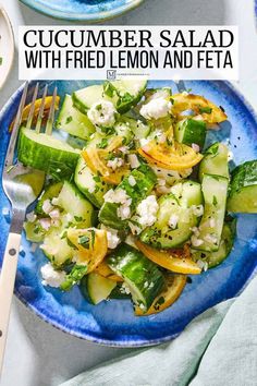 cucumber salad with fried lemon and feta on a blue plate next to a fork