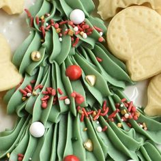 a christmas tree shaped cookie next to cookies