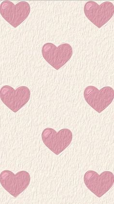 pink hearts are arranged in the shape of heart shapes on a white wallpaper background