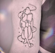 a woman's arm with a tattoo on it that has an image of two people hugging