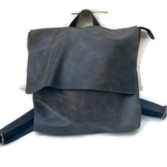 Minimalist Distressed Grey Leather Backpack. Handmade. 13” Wide 15” Tall 3” Deep Flap Closure With Top Zipper Outer Slide-In Pocket Inner Slide-In Pocket Rectangular Waxed Finish Backpack For On-the-go, Everyday Rectangular Leather Backpack With Waxed Finish, Everyday Use Leather Backpack With Waxed Finish, Rectangular Leather Backpack With Waxed Finish For Everyday, Rectangular Everyday Leather Backpack With Waxed Finish, Everyday Rectangular Soft Leather Backpack, Daily Use Leather Backpack With Waxed Finish, Daily Use Rectangular Leather Backpack With Waxed Finish, Casual Soft Leather Rectangular Backpack