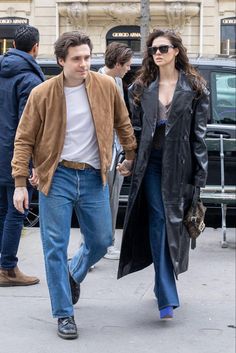 a man and woman walking down the street