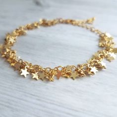 Tiny clusters of gold miniature star fringe, finished with an adjustable chain and lobster claw clasp. 14k gold plated brass. Now available in a soft matte silver rhodium finish {not shown}. { M e a s u r e m e n t s } Bracelet shown adjusts to fit approx 6.25 - 8 in (15 - 19.5cm). Each little star is approx 1/4 inch {approx 5mm} tall. Please double check measurements on your own wrist prior to any purchase, if you have any doubt or concern about the fit. I'm happy to shorten the length free of Lucky Charm Bracelet, S Bracelet, Good Luck Bracelet, Good Luck Gifts, Star Chain, Star Bracelet, Bar Earrings, Gold Star, Lucky Charm