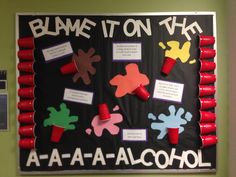 a bulletin board with some red cups on it