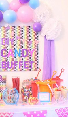 a candy buffet table with balloons, candies and other items on it for a birthday party