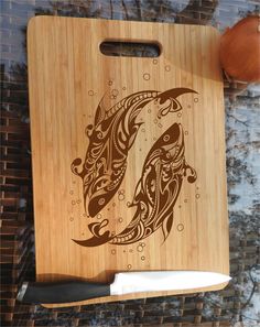 a cutting board with an image of two fish on it