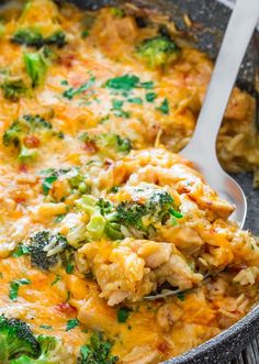 a casserole dish with broccoli and chicken is being scooped from the pan