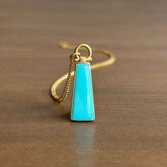 Mined in Globe, Arizona, this azure Sleeping Beauty turquoise is elegantly framed in gold, making for a sumptuous pendant. 

18k yellow gold 
Turquoise, 2.8ct, 9mm x 22mm (3/8" x 7/8")
Chain is 18" long Globe Arizona, Cast Rings, Elongated Oval, Chalcedony Ring, Newport Ri, Sleeping Beauty Turquoise, Turquoise Earrings, Bracelet Gift, Ring Necklace