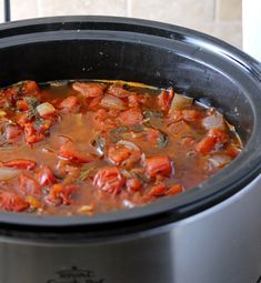 a slow cooker filled with stew and vegetables