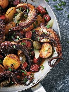 an octopus and potatoes dish in a pan