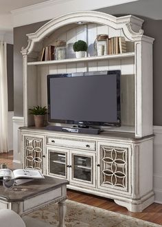 a white entertainment center in a living room