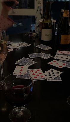 a table topped with wine glasses and cards