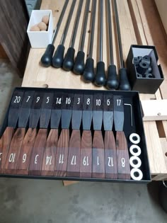 a wooden table topped with lots of different types of tools