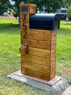 a mailbox sitting on top of a wooden box