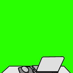 an open laptop computer sitting on top of a white desk in front of a green screen