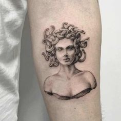 a woman's head with curly hair and curls tattooed on the arm by an artist