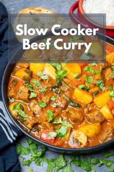 slow cooker beef curry in a bowl with rice and cilantro on the side