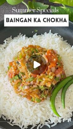 a black plate topped with rice and vegetables