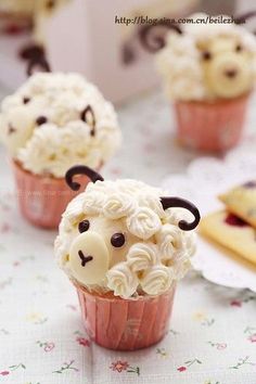 cupcakes with icing in the shape of sheep's heads on top