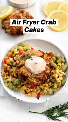 air fryer crab cakes in a white bowl with corn and garnishes