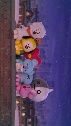 there are many stuffed animals hanging from the ceiling in front of a building at night