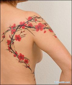 a woman's back with red flowers painted on her upper and lower part,