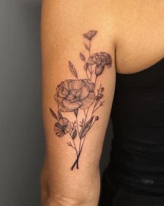 a woman's arm with a flower tattoo on the left side of her arm