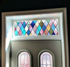 two stained glass windows in front of a door