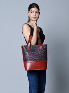 Introducing the handcrafted leather structured tote, where traditional craft meets modern design. The upper portion features authentic Ajrakh printed fabric stitched on durable leather, infusing a traditional and ethnic feel. With sturdy leather handles and a spacious central compartment, it accommodates books, journals, diaries, and laptops with ease. Crafted from naturally tanned buffalo leather, this tote embraces a chemical-free approach, allowing you to carry a piece of cultural heritage wi Traditional Leather Shoulder Bag, Traditional Leather Tote Bag, Traditional Leather Tote Shoulder Bag, Traditional Leather Shoulder Bag For Everyday, Traditional Bags With Leather Lining For Everyday Use, Traditional Bag With Leather Lining For Everyday Use, Traditional Daily Shoulder Bag With Leather Lining, Traditional Leather Lined Shoulder Bag For Daily Use, Books Journal