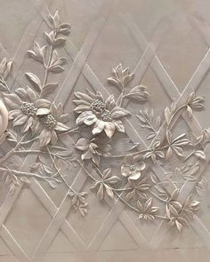 an intricately designed wall with flowers and leaves