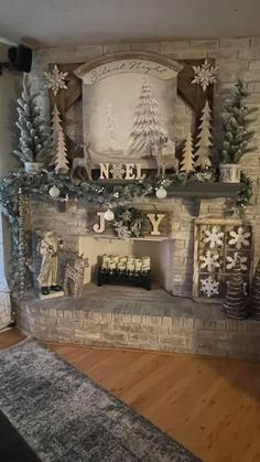 a fireplace decorated for christmas with snowflakes and trees on it's mantle