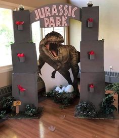 an inflatable t - rex is on display at the entrance to a dinosaur park