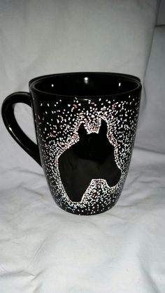 a black coffee cup with white dots on it