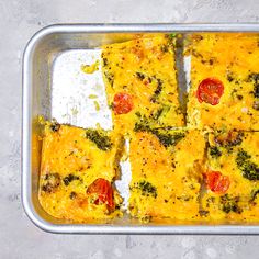 a pan filled with broccoli and cheese casserole on top of a table