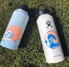 two water bottles laying on the grass