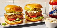 two chicken burgers with lettuce, tomato and mayonnaise