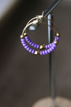 Lovely summer earrings with soft purple glass seed beads, gold tone sphere beads and gold tone stainless steel round hoop earrings. Earring hooks are from nickel free and lead free metal. Perfect jewelry for everyday wear or a great gift for someone special! Diameter of hoops is 25 mm. Other earrings of my shop you can see here: https://www.etsy.com/shop/NaTavelli?section_id=13757927 Thanks for visit. Everyday Purple Jewelry With Colorful Beads, Gold Small Hoop Earrings With Spacer Beads, Nickel-free Purple Beaded Earrings With Round Beads, Nickel-free Purple Beaded Earrings, Purple Adjustable Earrings With Tiny Beads, Adjustable Purple Earrings With Tiny Beads, Adjustable Nickel-free Purple Hoop Earrings, Everyday Gold Beaded Round Earrings, Everyday Gold Beaded Earrings