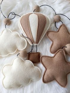 three felt hot air balloons on a fluffy white surface