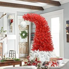 a living room decorated for christmas with red and white decorations