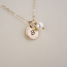 The gold initial of your choice will hang beside a petite freshwater pearl. I hand stamp the initial, than apply a pretty, hammered edge. Charms are also available with a plain, smooth edge if you prefer. All metal findings are 14K gold fill. Initial charms measure about 10mm across. Necklace chain measures about 18 inches in length and is secured with a spring ring clasp. >>To enter to my shop<< http://www.kgarnerdesigns.etsy.com Please contact me PRIOR TO PURCHASE if you are orderi Dainty Charm Necklaces With Pearl Initial Pendant, Dainty Pearl Charm Necklace With Initial Pendant, Pearl Necklace Gold, Gold Initial Necklace, Gold Letter Necklace, Gold Letter, Initial Necklace Gold, Gold Pearl Necklace, Gold Charm Necklace