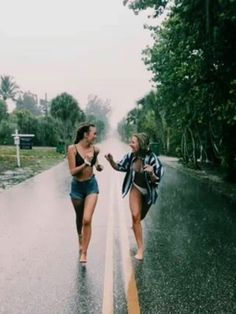 two women walking in the rain holding hands